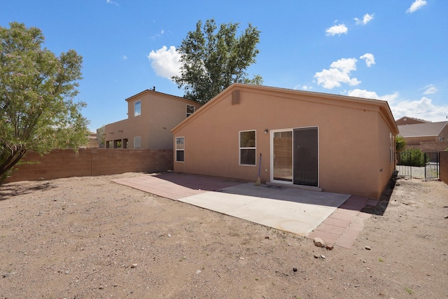 1944 Sierra Norte Loop NE, Rio Rancho, NM 87144 - back of property featuring stucco siding, a fenced backyard, and a patio