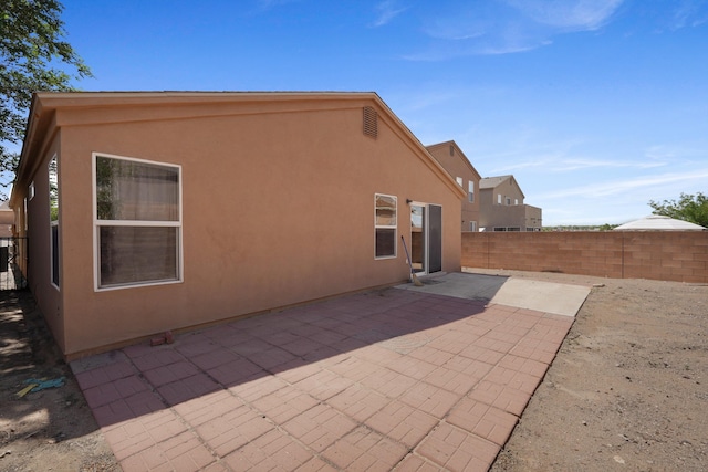 1944 Sierra Norte Loop NE, Rio Rancho, NM 87144 - back of property featuring stucco siding, a fenced backyard, and a patio area