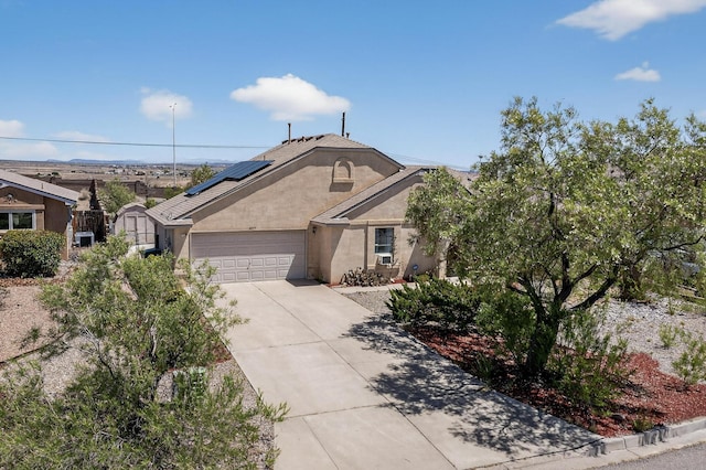 4577 Rockaway Loop NE, Rio Rancho, NM 87124 - single story home featuring stucco siding, driveway, a garage, and roof mounted solar panels