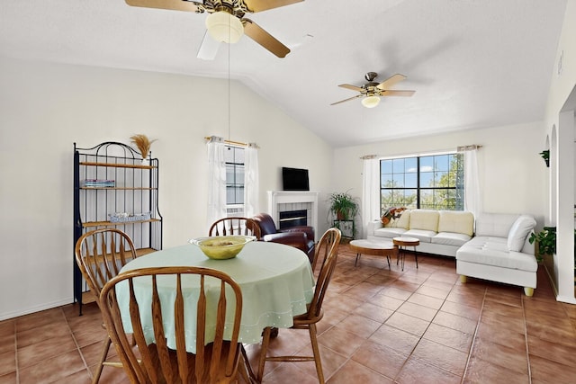 4577 Rockaway Loop NE, Rio Rancho, NM 87124 - dining space featuring ceiling fan, lofted ceiling, a tiled fireplace, and tile patterned flooring