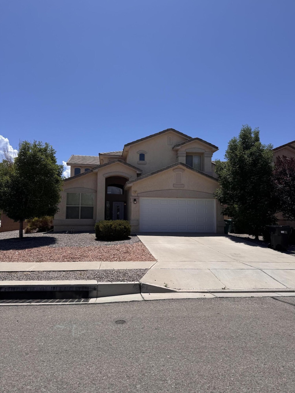 2107 Violeta Cir SE, Rio Rancho, NM 87124 - mediterranean / spanish house featuring stucco siding, driveway, and a garage