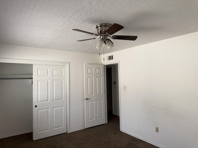 8333 Comanche Rd NE Unit 10B, Albuquerque, NM 87110 - unfurnished bedroom with dark carpet, a closet, a textured ceiling, and a ceiling fan