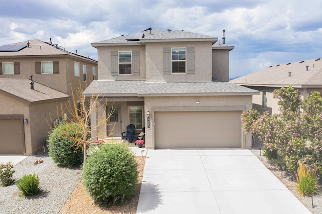 4823 Blackburn Rd NE, Rio Rancho, NM 87144 - traditional-style home with stucco siding, roof with shingles, solar panels, driveway, and a garage