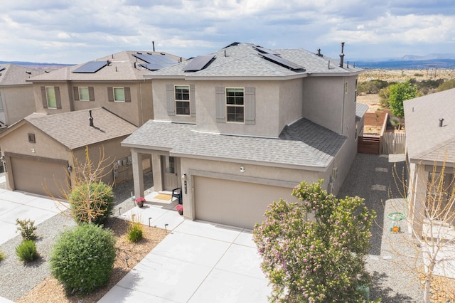 4823 Blackburn Rd NE, Rio Rancho, NM 87144 - view of front of home featuring driveway, stucco siding, a garage, and roof mounted solar panels