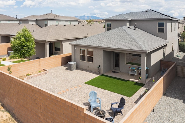 4823 Blackburn Rd NE, Rio Rancho, NM 87144 - rear view of house featuring a shingled roof, stucco siding, a fenced backyard, and a patio