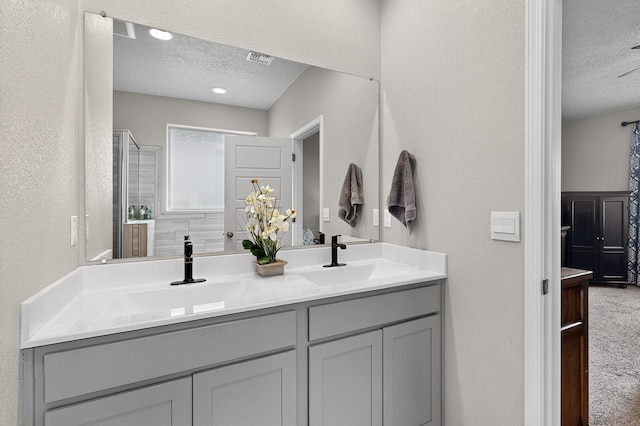 4823 Blackburn Rd NE, Rio Rancho, NM 87144 - full bath featuring a textured ceiling, a textured wall, and double vanity