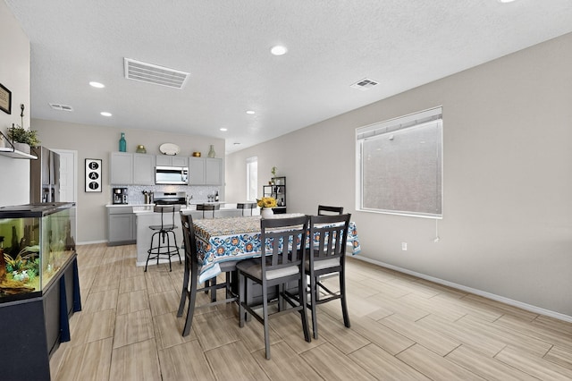 4823 Blackburn Rd NE, Rio Rancho, NM 87144 - dining area featuring recessed lighting, a textured ceiling, and wood finish floors