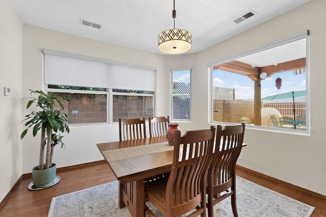 1324 Wilkes Way SE, Rio Rancho, NM 87124 - dining space featuring wood finished floors and a textured ceiling