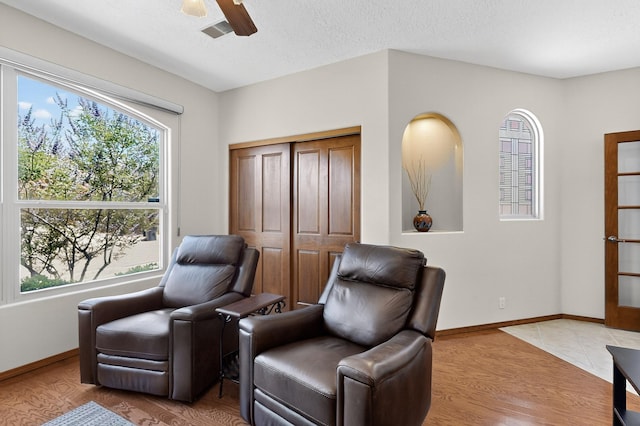 1324 Wilkes Way SE, Rio Rancho, NM 87124 - sitting room featuring a ceiling fan, light wood-style floors, and a textured ceiling