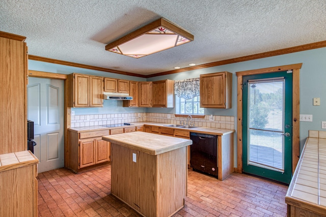 10 Quail Run Rd, Tijeras, NM 87059 - kitchen with black appliances, under cabinet range hood, tile counters, brick floors, and crown molding