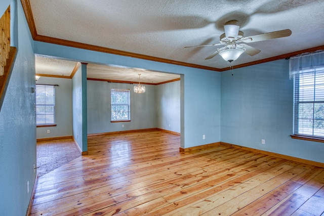 10 Quail Run Rd, Tijeras, NM 87059 - unfurnished room featuring hardwood / wood-style floors, a textured ceiling, healthy amount of natural light, ornamental molding, and a ceiling fan