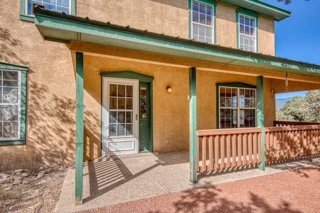 10 Quail Run Rd, Tijeras, NM 87059 - doorway to property featuring stucco siding and a porch