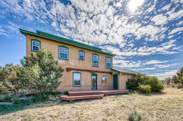 10 Quail Run Rd, Tijeras, NM 87059 - rear view of property with a wooden deck, stucco siding, a lawn, and a metal roof