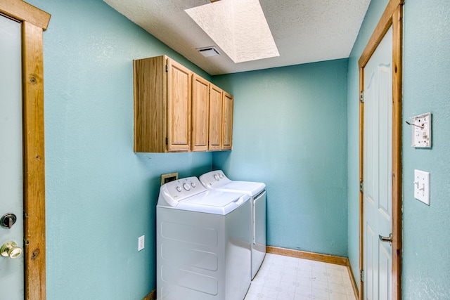 10 Quail Run Rd, Tijeras, NM 87059 - laundry area with cabinet space, light floors, a skylight, independent washer and dryer, and a textured ceiling