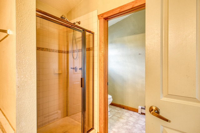 10 Quail Run Rd, Tijeras, NM 87059 - bathroom with baseboard heating, a stall shower, and tile patterned floors