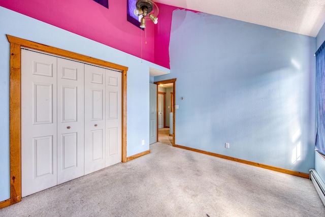 10 Quail Run Rd, Tijeras, NM 87059 - unfurnished bedroom featuring carpet, vaulted ceiling, a closet, a baseboard heating unit, and a textured ceiling