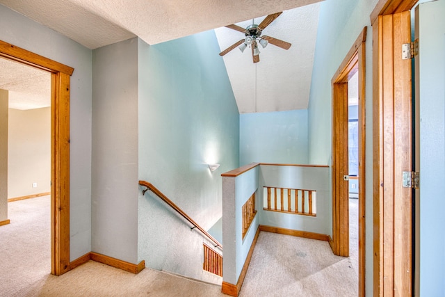 10 Quail Run Rd, Tijeras, NM 87059 - stairway with carpet flooring, a textured ceiling, a ceiling fan, and vaulted ceiling