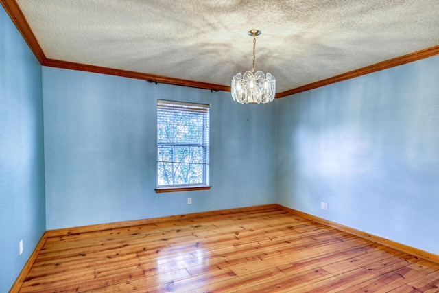 10 Quail Run Rd, Tijeras, NM 87059 - empty room with crown molding, a chandelier, wood-type flooring, and a textured ceiling