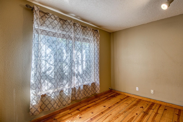 10 Quail Run Rd, Tijeras, NM 87059 - spare room with wood-type flooring and a textured ceiling