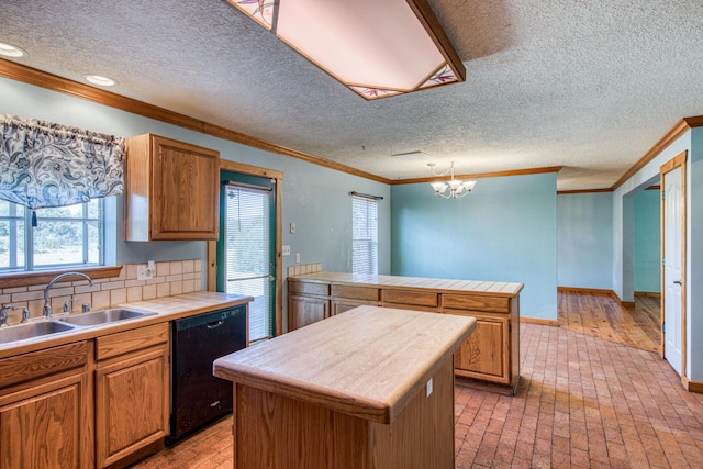10 Quail Run Rd, Tijeras, NM 87059 - kitchen with black dishwasher, crown molding, healthy amount of natural light, a peninsula, and a center island