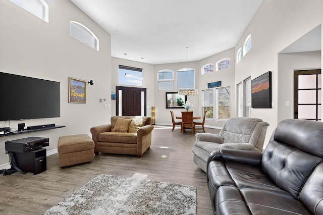 6205 Peachtree Pl NE, Albuquerque, NM 87111 - living room with a high ceiling, wood finished floors, and a chandelier
