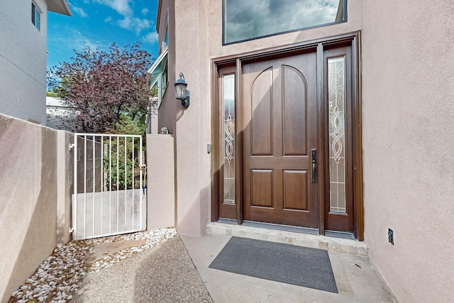 6205 Peachtree Pl NE, Albuquerque, NM 87111 - entrance to property with stucco siding and a gate
