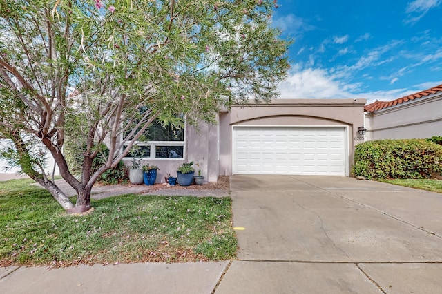 6205 Peachtree Pl NE, Albuquerque, NM 87111 - view of front of property featuring a garage, concrete driveway, and stucco siding