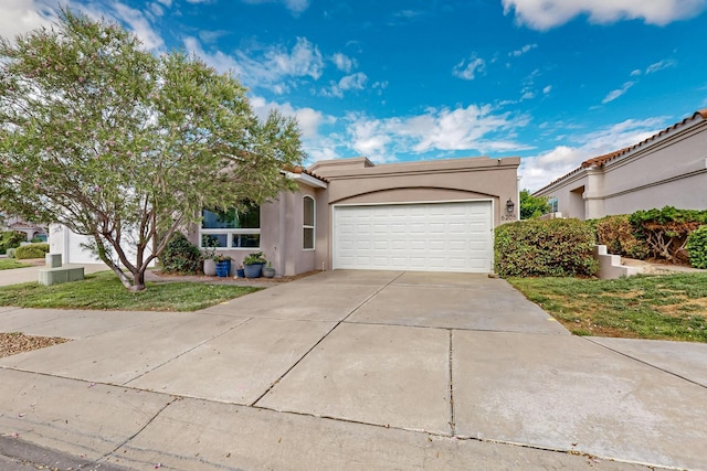 6205 Peachtree Pl NE, Albuquerque, NM 87111 - view of front of home featuring an attached garage, stucco siding, and concrete driveway