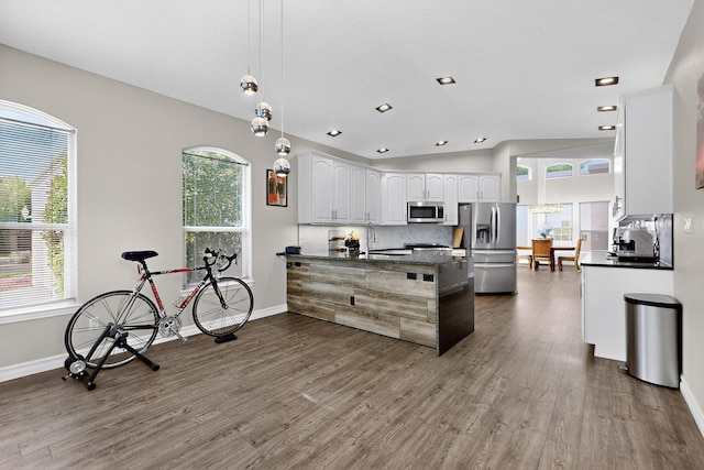 6205 Peachtree Pl NE, Albuquerque, NM 87111 - kitchen featuring appliances with stainless steel finishes, a peninsula, dark wood-style floors, white cabinetry, and recessed lighting