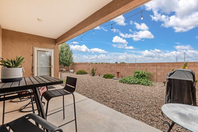 2660 Firewheel Ave SW, Los Lunas, NM 87031 - fenced backyard featuring a patio and outdoor dining space