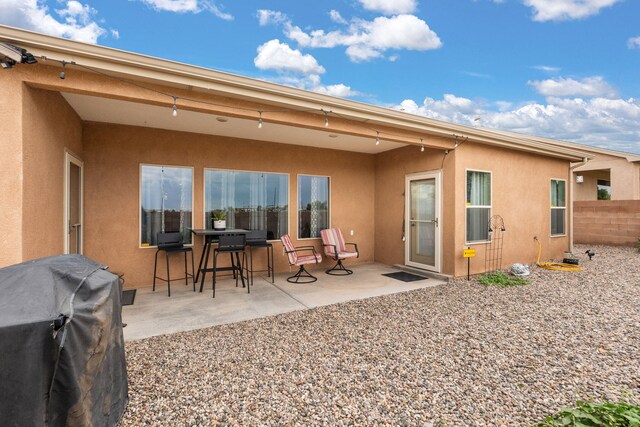2660 Firewheel Ave SW, Los Lunas, NM 87031 - rear view of house featuring stucco siding and a patio area