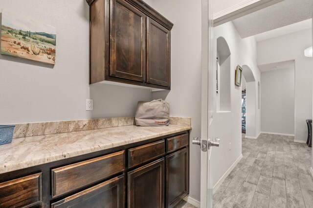 2660 Firewheel Ave SW, Los Lunas, NM 87031 - washroom with arched walkways and light wood-style floors
