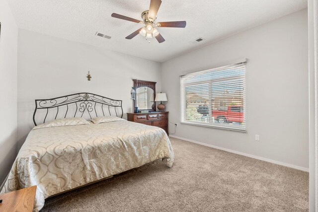 2660 Firewheel Ave SW, Los Lunas, NM 87031 - bedroom with carpet floors, a textured ceiling, and a ceiling fan