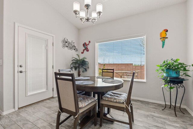 2660 Firewheel Ave SW, Los Lunas, NM 87031 - dining space with a chandelier, light wood-style floors, and vaulted ceiling