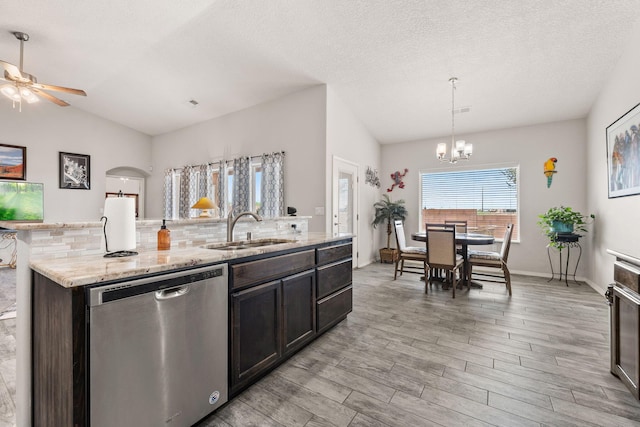 2660 Firewheel Ave SW, Los Lunas, NM 87031 - kitchen featuring dishwasher, a chandelier, light wood-style floors, a center island with sink, and a ceiling fan