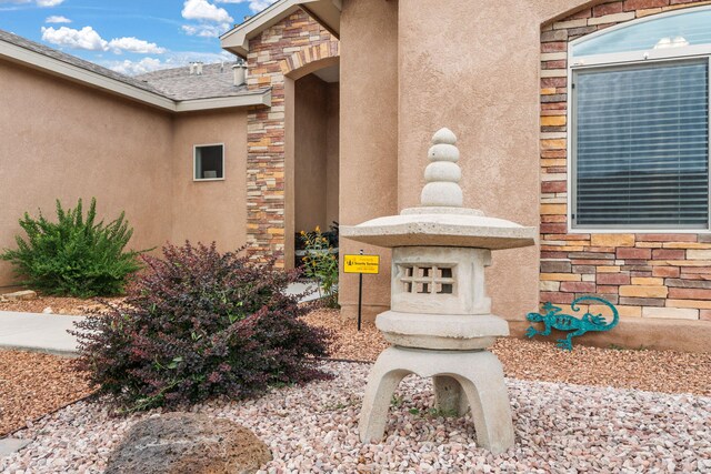 2660 Firewheel Ave SW, Los Lunas, NM 87031 - view of exterior entry with stone siding and stucco siding