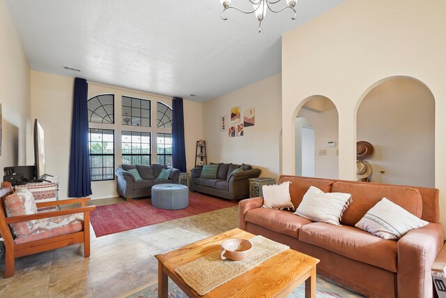 6268 Apache Plume Rd NE, Rio Rancho, NM 87144 - living room with arched walkways and a chandelier