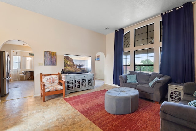 6268 Apache Plume Rd NE, Rio Rancho, NM 87144 - living area featuring arched walkways and healthy amount of natural light