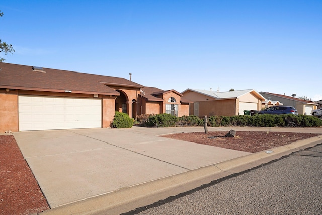 6268 Apache Plume Rd NE, Rio Rancho, NM 87144 - ranch-style home with concrete driveway, a garage, and stucco siding
