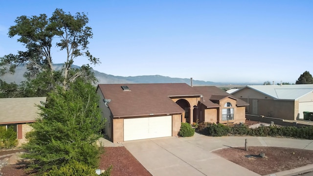6268 Apache Plume Rd NE, Rio Rancho, NM 87144 - view of front of house featuring driveway, stucco siding, a mountain view, and a garage