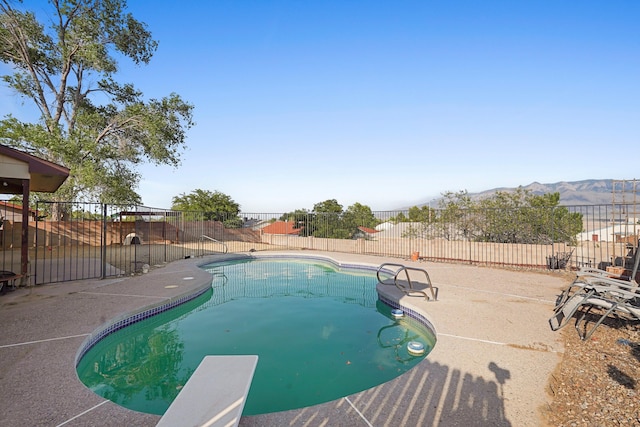 6268 Apache Plume Rd NE, Rio Rancho, NM 87144 - view of swimming pool featuring a fenced backyard, a patio, a diving board, and a mountain view