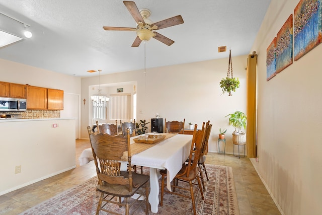 6268 Apache Plume Rd NE, Rio Rancho, NM 87144 - dining room featuring a chandelier and ceiling fan