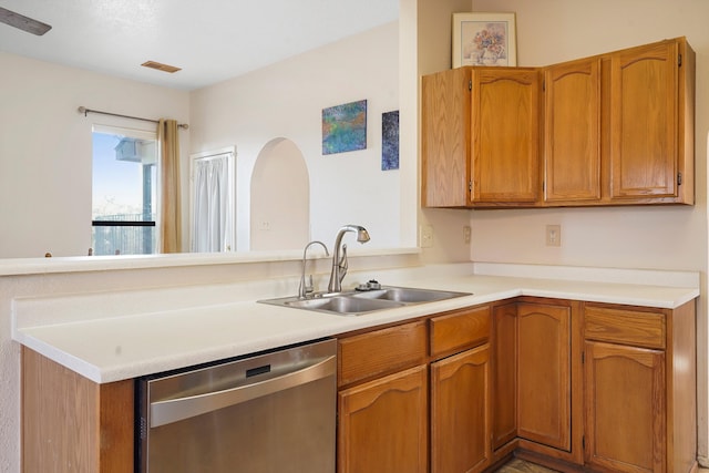 6268 Apache Plume Rd NE, Rio Rancho, NM 87144 - kitchen with stainless steel dishwasher, a peninsula, light countertops, and brown cabinetry