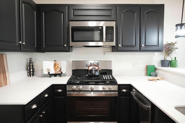 4441 Kellia Ln NE, Albuquerque, NM 87111 - kitchen with appliances with stainless steel finishes, dark cabinetry, and light countertops