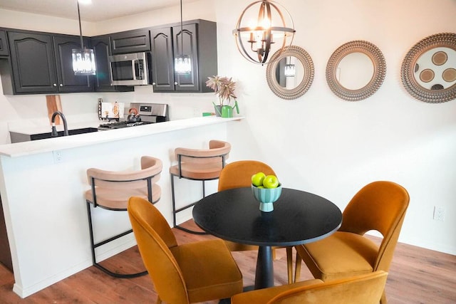 4441 Kellia Ln NE, Albuquerque, NM 87111 - dining space featuring wood finished floors and a chandelier