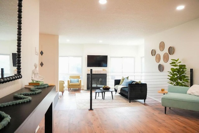 4441 Kellia Ln NE, Albuquerque, NM 87111 - living area with recessed lighting, wood finished floors, and a glass covered fireplace
