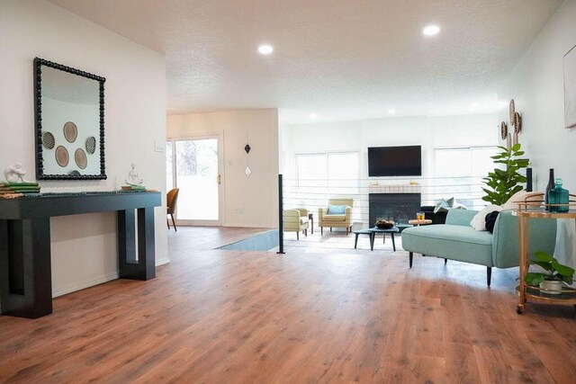 4441 Kellia Ln NE, Albuquerque, NM 87111 - living area with recessed lighting, wood finished floors, a fireplace, and a textured ceiling
