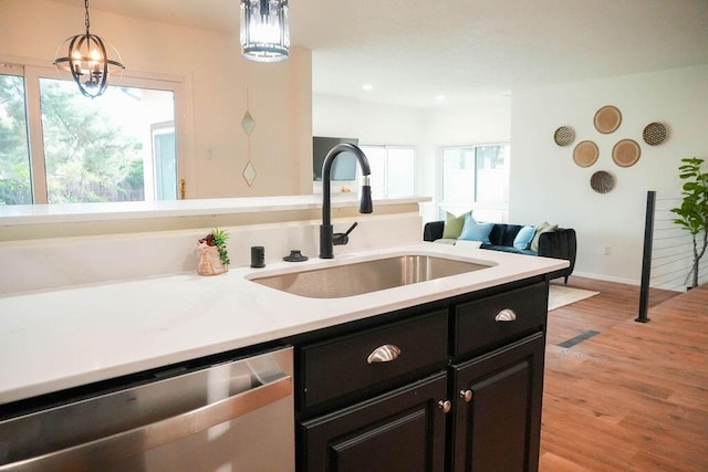 4441 Kellia Ln NE, Albuquerque, NM 87111 - kitchen featuring dishwasher, light countertops, light wood-style flooring, decorative light fixtures, and recessed lighting