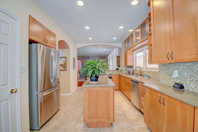 6749 Kelly Ann Rd NE, Albuquerque, NM 87109 - kitchen featuring stainless steel appliances, tasteful backsplash, light stone counters, recessed lighting, and a center island