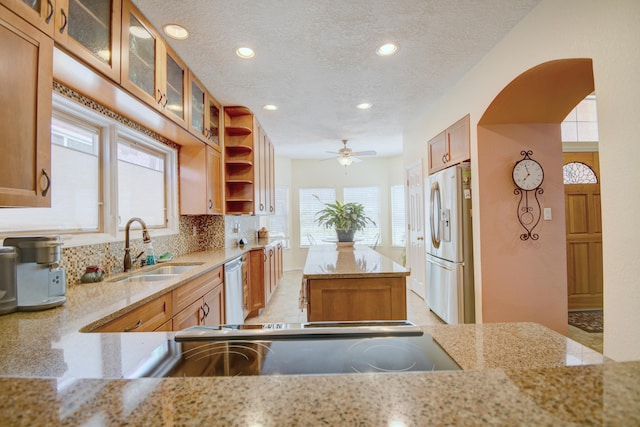 6749 Kelly Ann Rd NE, Albuquerque, NM 87109 - kitchen with appliances with stainless steel finishes, open shelves, recessed lighting, light stone counters, and tasteful backsplash